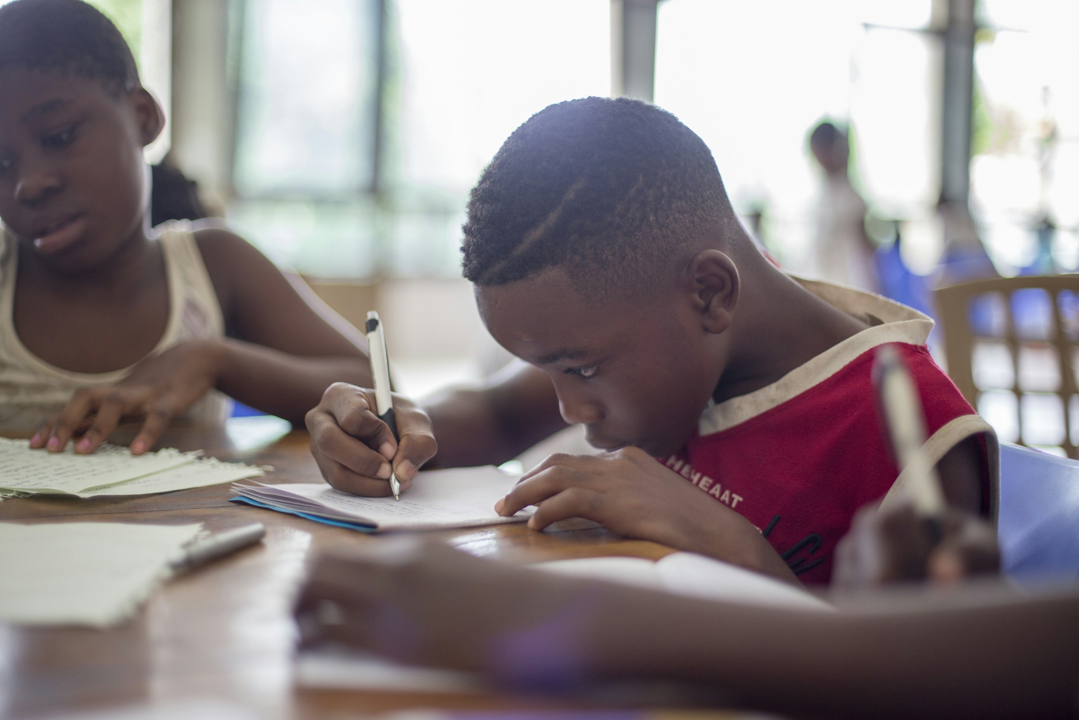 A student concentrating on a writing exercise